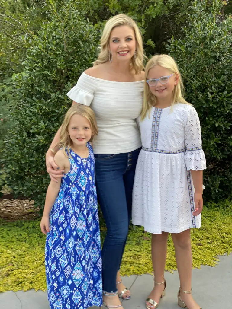 Two young girls posing with adult woman