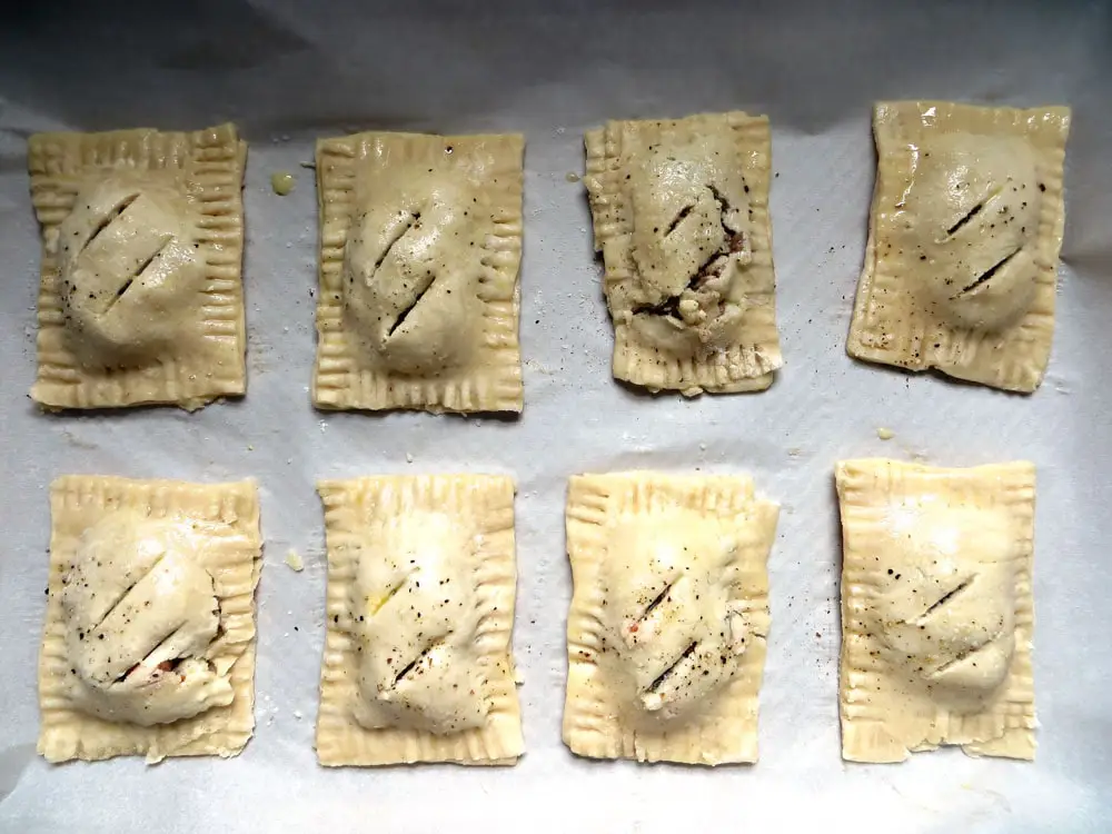 unbaked filled hand pies sealed with fork tines on the edges and scored on the tops