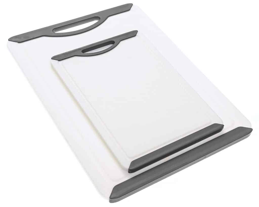 two white plastic cutting boards with gray handles