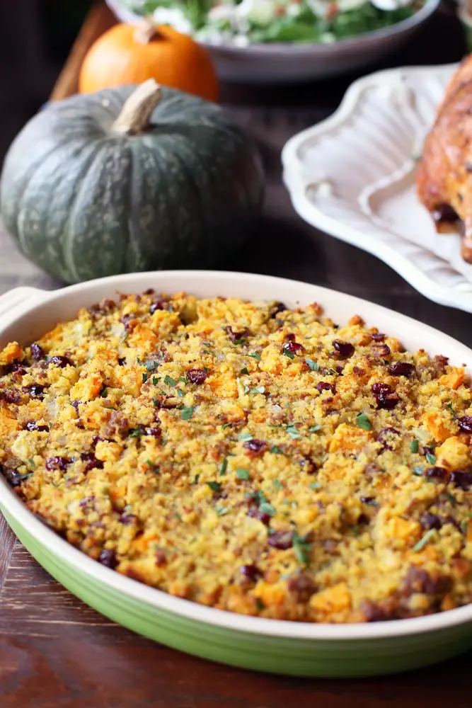 cornbread with bits of sausage in an oval casserole dish