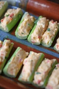 pimento cheese filled celery sticks on a serving platter