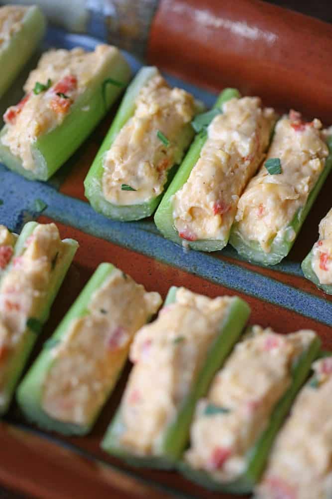 pimento cheese filled celery sticks on a serving platter