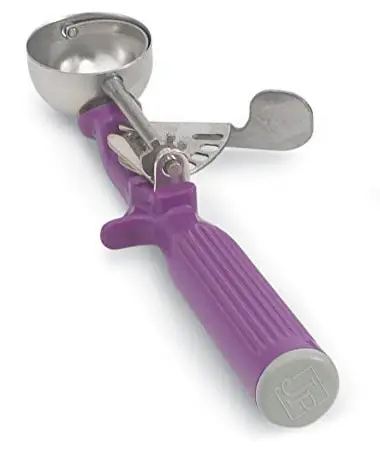 stainless cookie scooper with a purple plastic handle