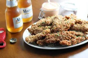 an oval white platter piled with crusted chicken tenders