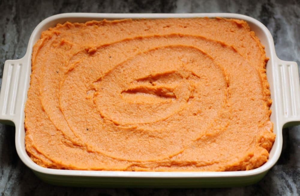 sweet potato puree swirled in a rectangular green baking dish