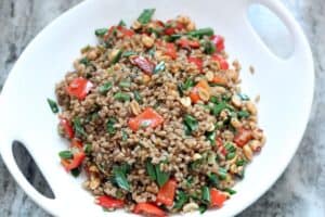 Crispy Farro with Peanuts, Scallions and Peppers in a white serving bowl
