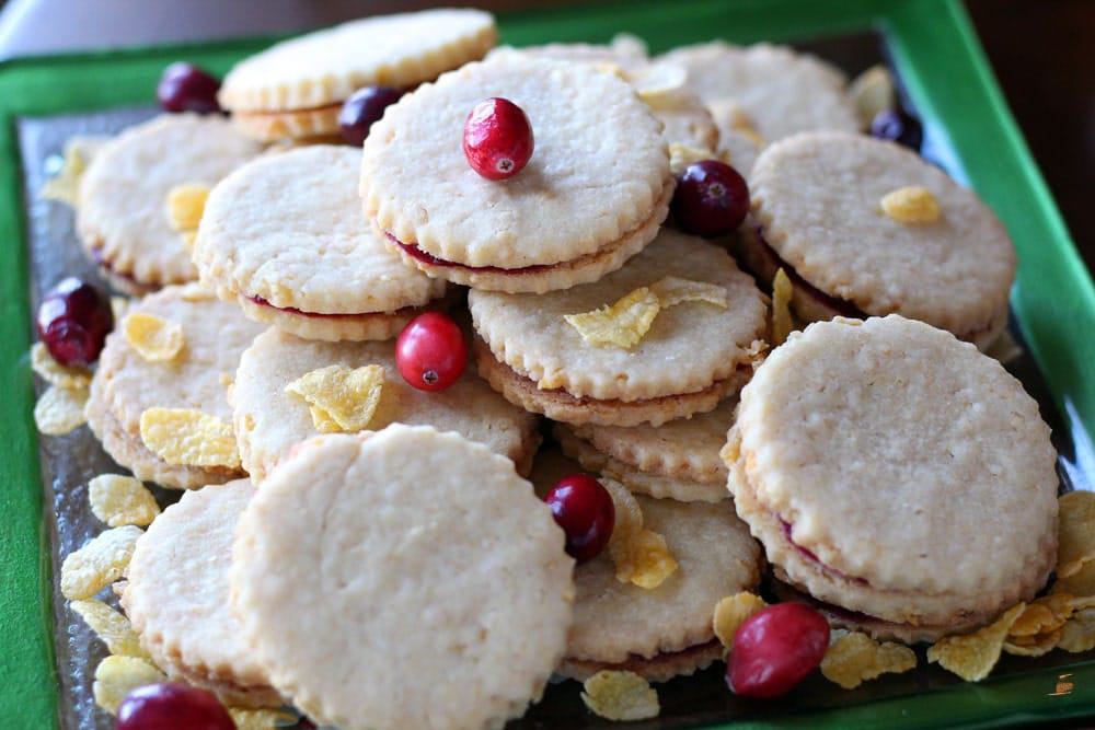 round sandwich cookies garnished with corn flake cereal and cranberries