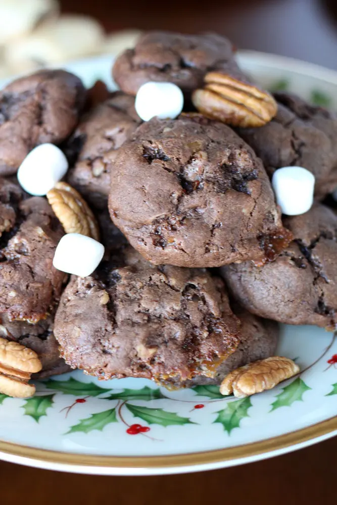 brown drop cookies on a plate with marshmallows and pecans