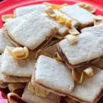 shortbread sandwich cookies filled with caramel and garnished with fritos