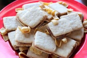 shortbread sandwich cookies filled with caramel and garnished with fritos