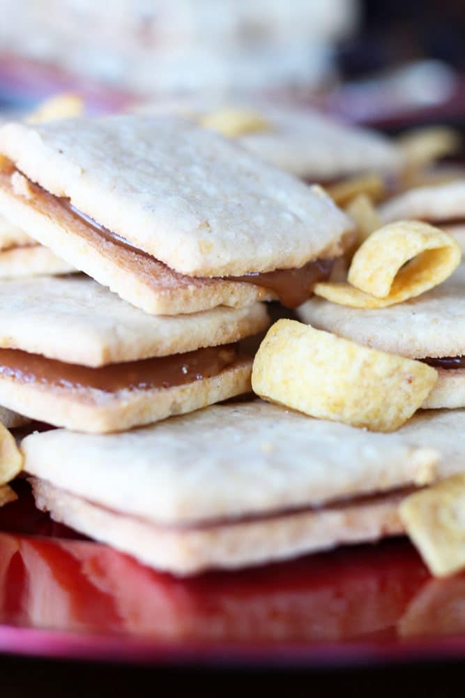 shortbread sandwich cookies filled with caramel and garnished with fritos