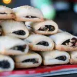 Fig Pecan Newton cookies stacked in a pyramid on a long red serving platter