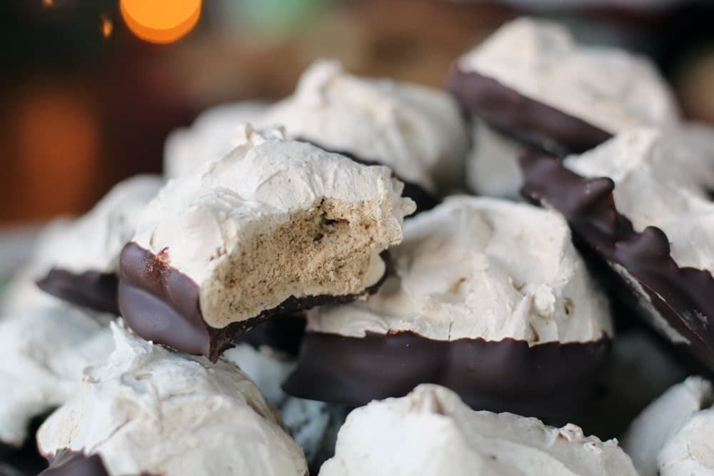 chocolate dipped meringue cookies piled on top of one another