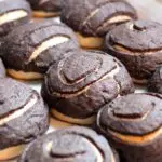 freshly baked rows of chocolate conchas on a baking sheet lined with parchment paper