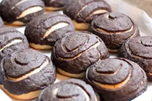 freshly baked rows of chocolate conchas on a baking sheet lined with parchment paper