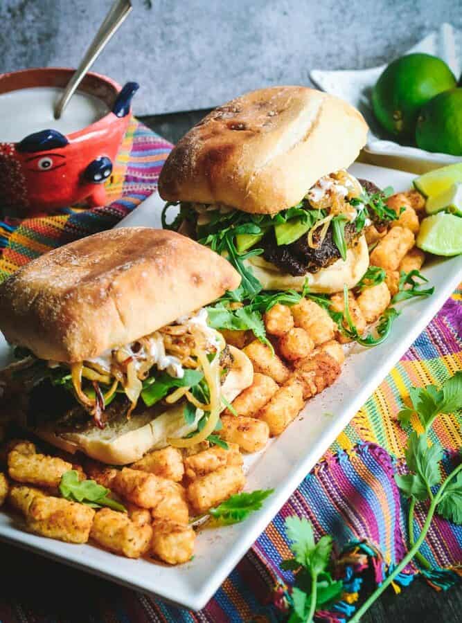 Cilantro Chicken Sandwiches with Chili-Spiced Tater Tots on a long rectangular white plate