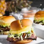 closeup shot of teriyaki steak and pineapple sliders with shredded cabbage peaking out