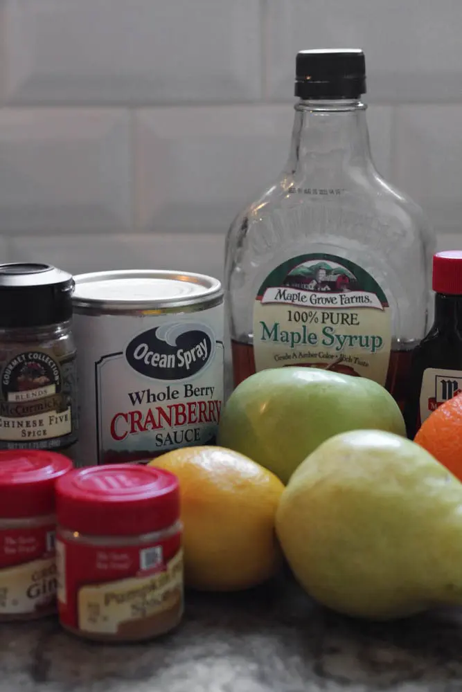 the ingredients required for Cranberry, Apple and Pear Bars which include chinese five spice, ground ginger, pumpkin pie spice, canned cranberry sauce, maple syrup, vanilla extract, lemon, orange, pear and apple