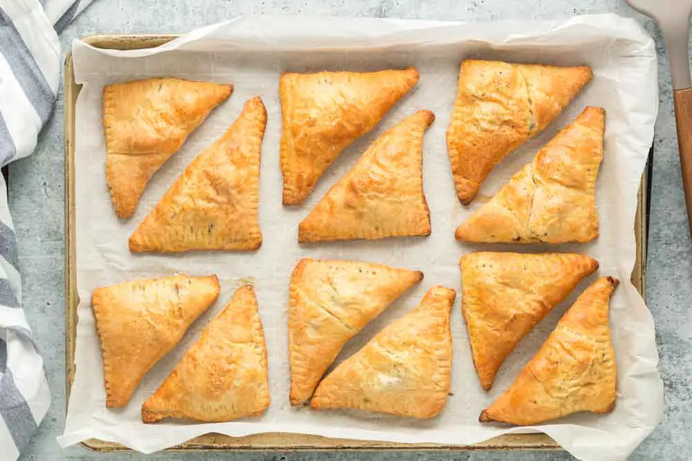 Louisiana Meat Pies on a parchment lined baking sheet