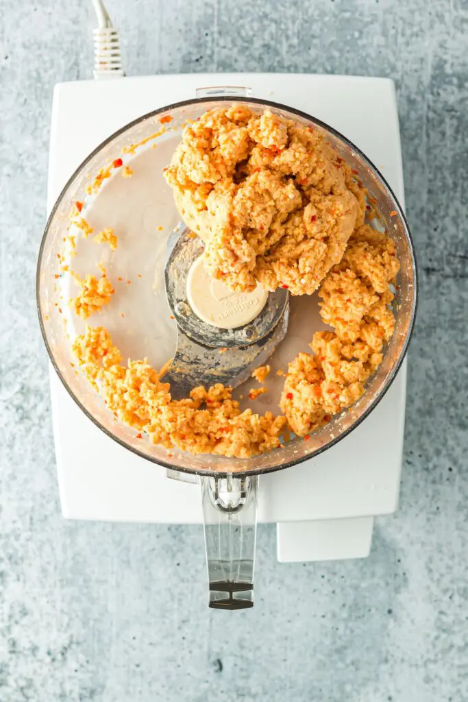 Pimento cheese, flour and water combined in a food processor until a dough ball forms