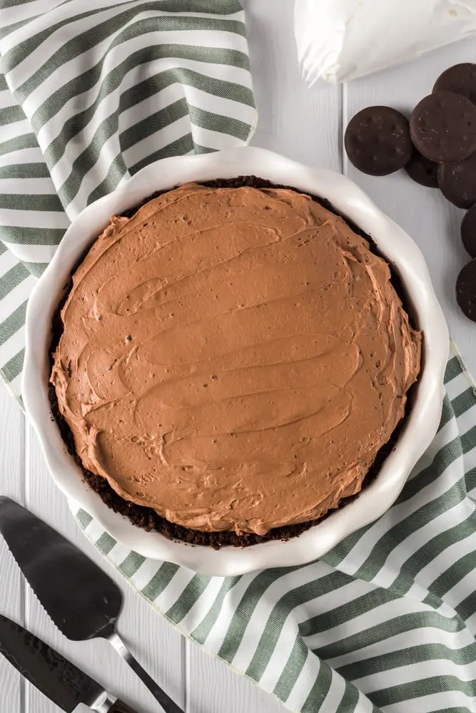 whole and unsliced brown thin mint no bake chocolate cheesecake before garnishing