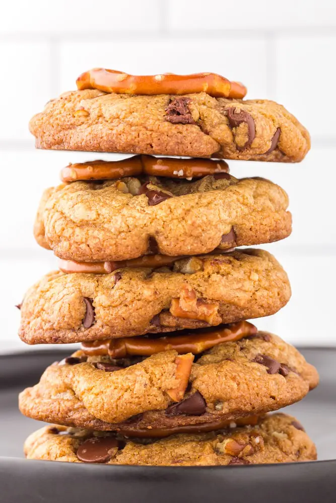 stack of Brown Butter Chocolate Chip Cookies with Pretzels on a black plate