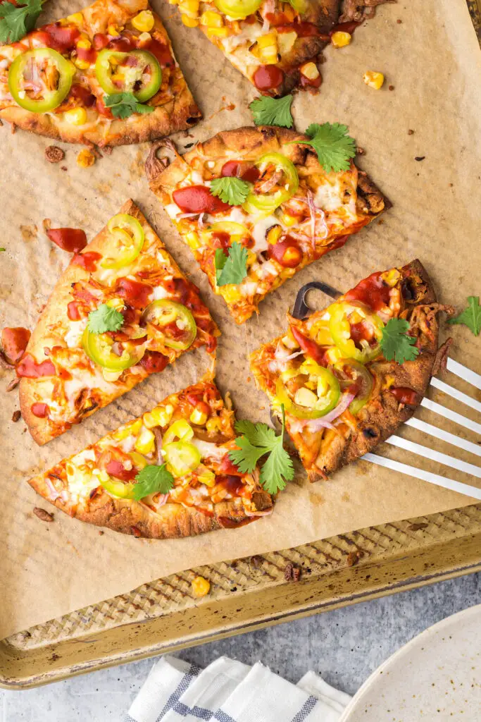 BBQ Chicken Flatbread being cut into four equal pieces