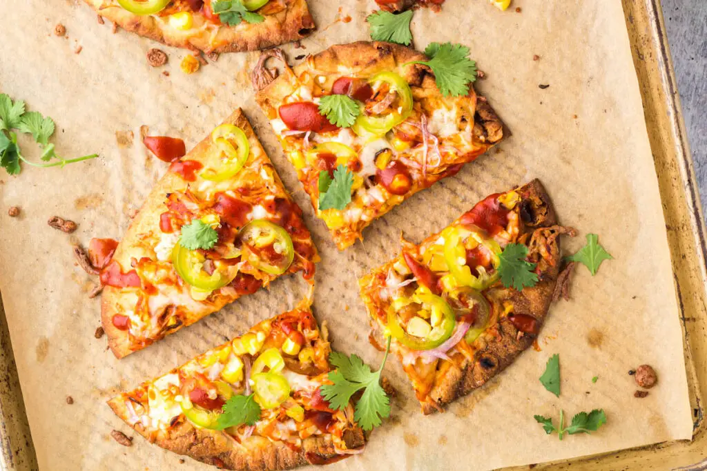 BBQ chicken flatbread cut into four equal pieces