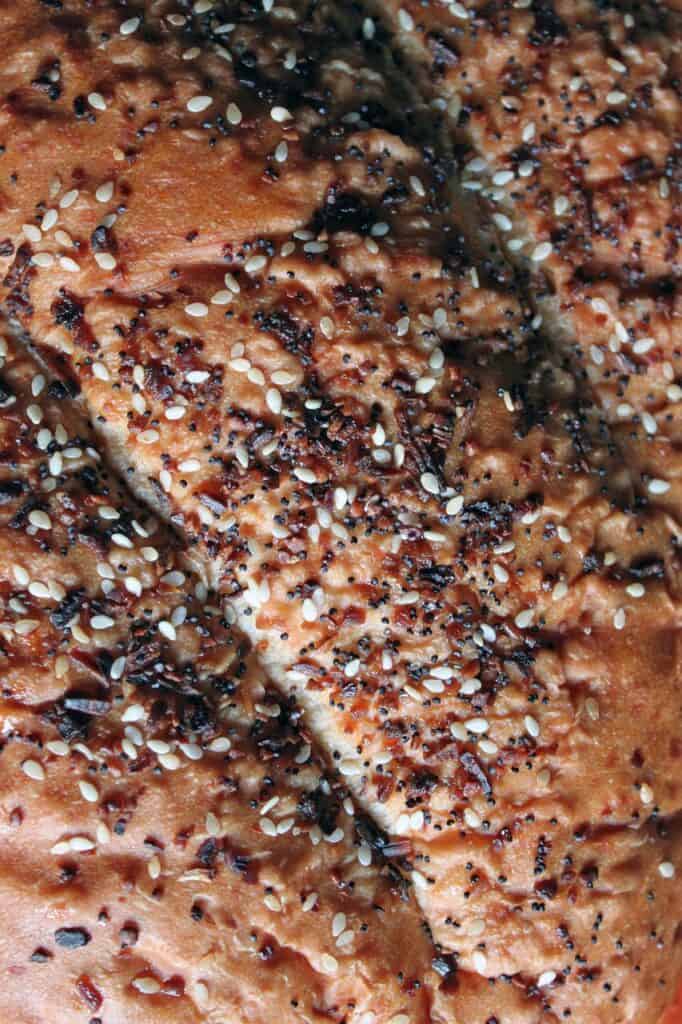 overhead close up of bread covered in everything bagel seasoning.