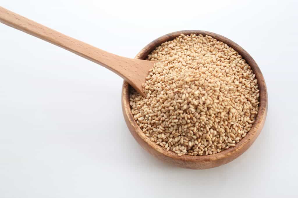 toasted sesame seeds in a small wooden bowl.