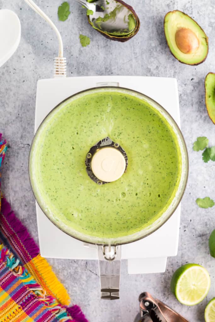 avocado sauce ingredients in the food processor after being pureed smooth