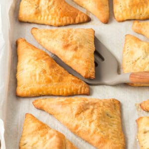 Close up of Louisiana Meat Pie on a parchment lined baking sheet.