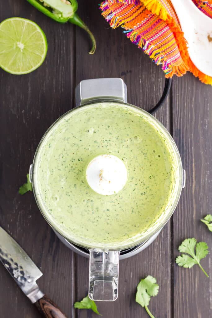 Cilantro Lime Sauce being pureed in a food processor.