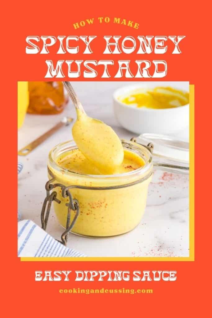 Bright yellow honey mustard dressing with flecks of red cayenne pepper in a small glass jar.