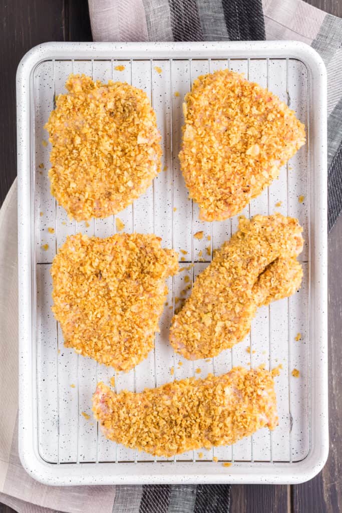 Sheet pan of French Onion Pork Chops before baking.