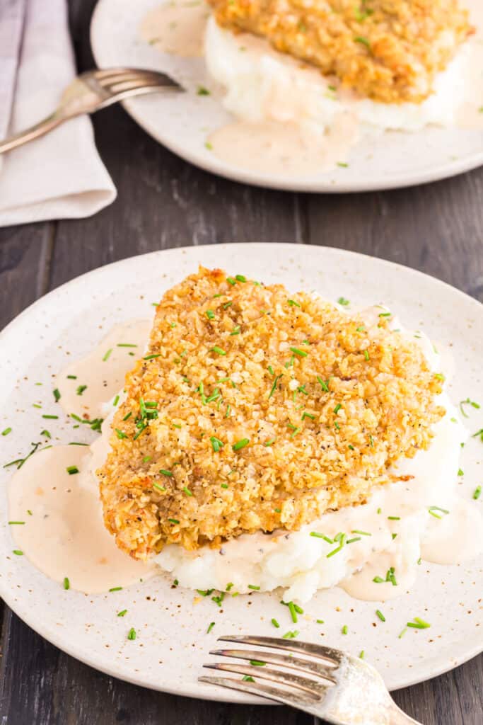 Close up of French Onion Pork Chops served over mashed potatoes.