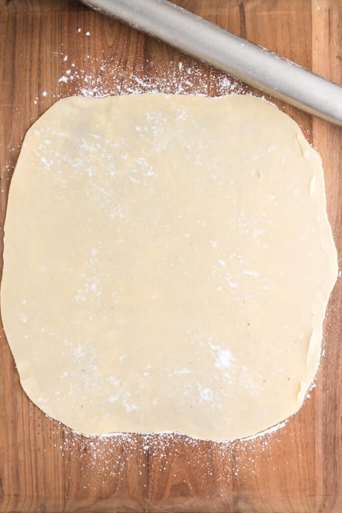 Pie crust rolled out on a wood surface