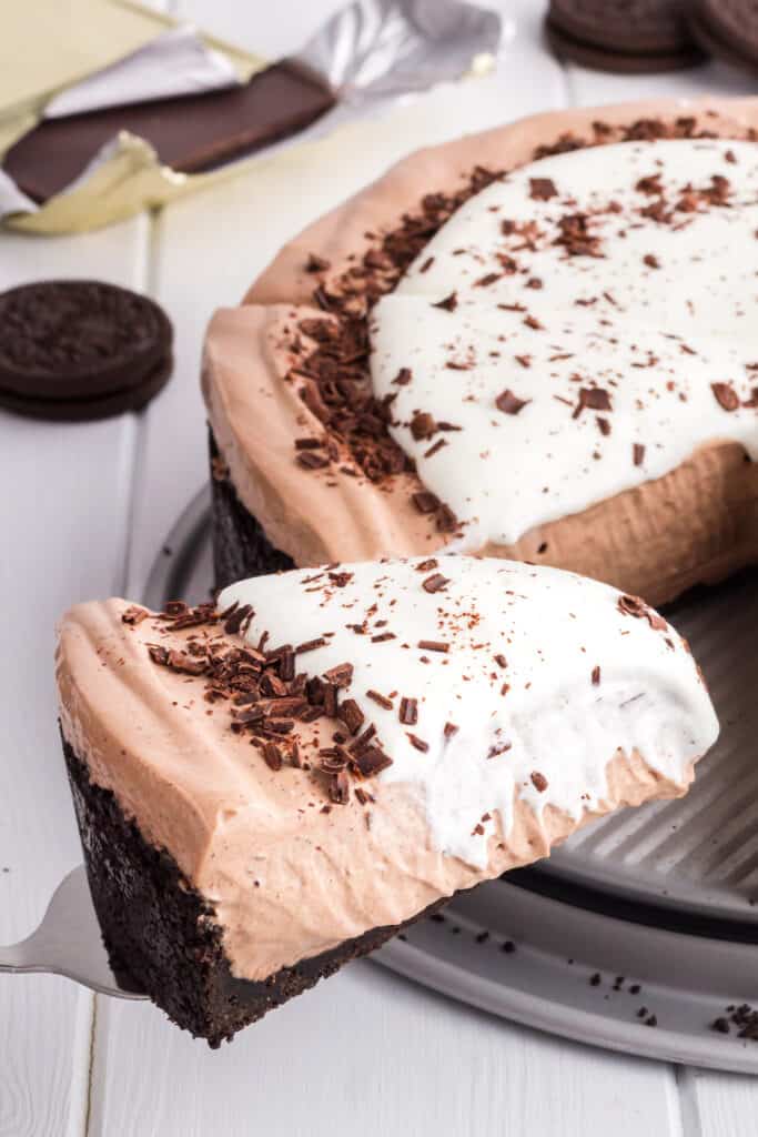 Slice of No-Bake Chocolate Cheesecake being removed from the whole pie