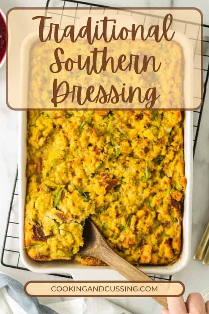 Traditional Southern Cornbread Dressing being scooped out of a white baking dish with a wooden sppon.