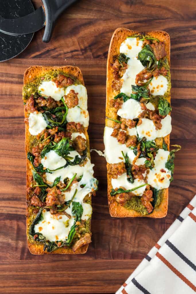 Air fryer french bread pizza on a dark wooden cutting board