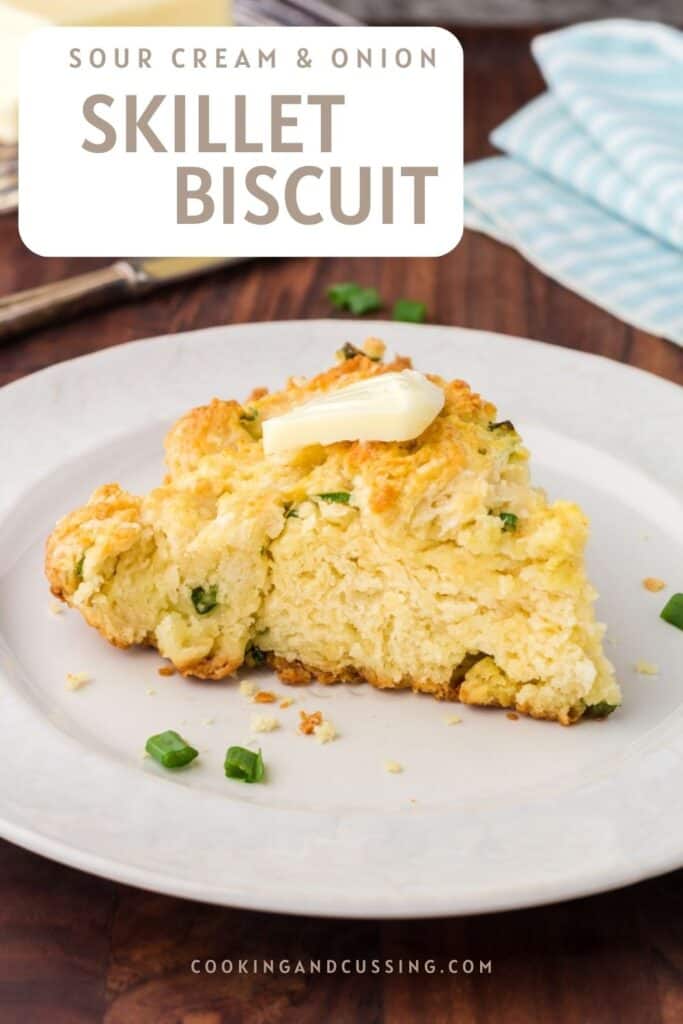 Skillet Biscuit on a white plate with a pat of butter on top.