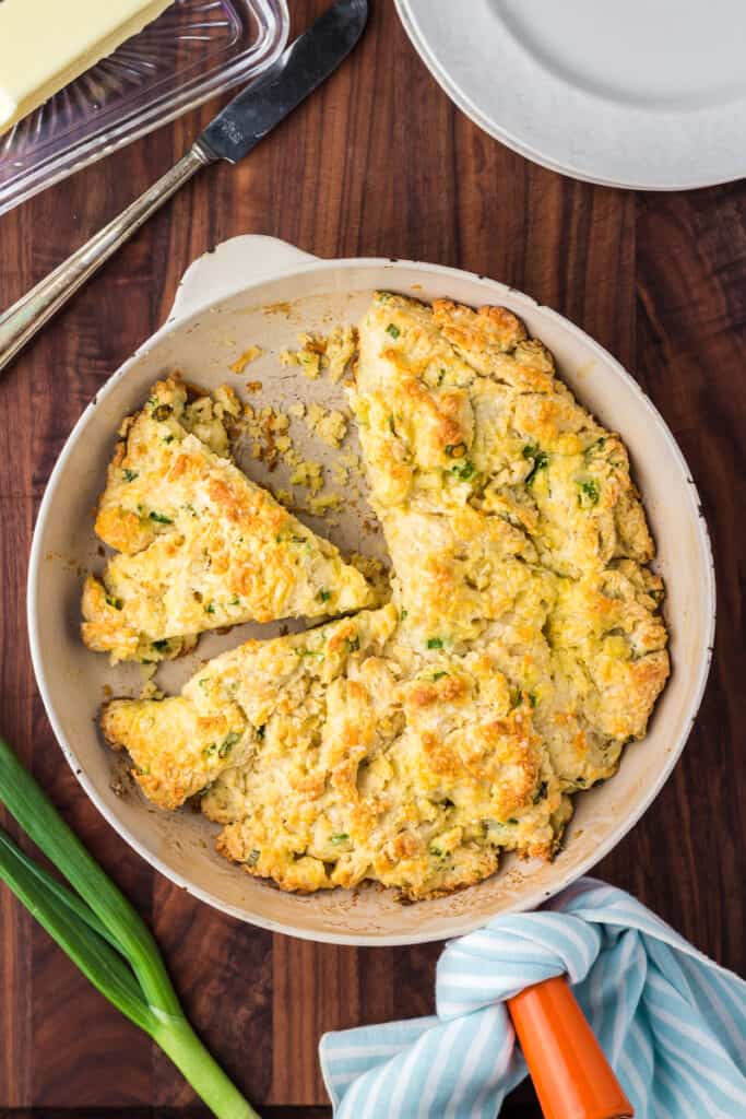 Overhead view of skillet biscuit sliced into wedges.