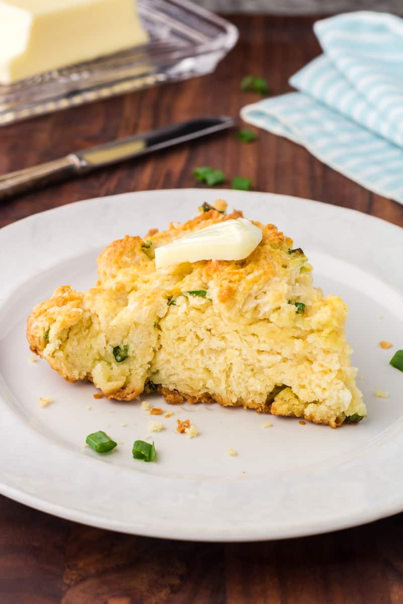 Skillet Biscuit on a white plate with a pat of butter on top.